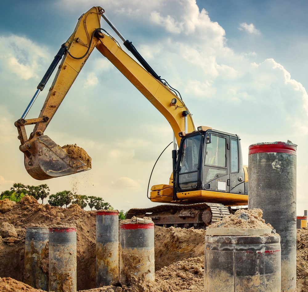 Overholt Grading digging ground around pillars at a site